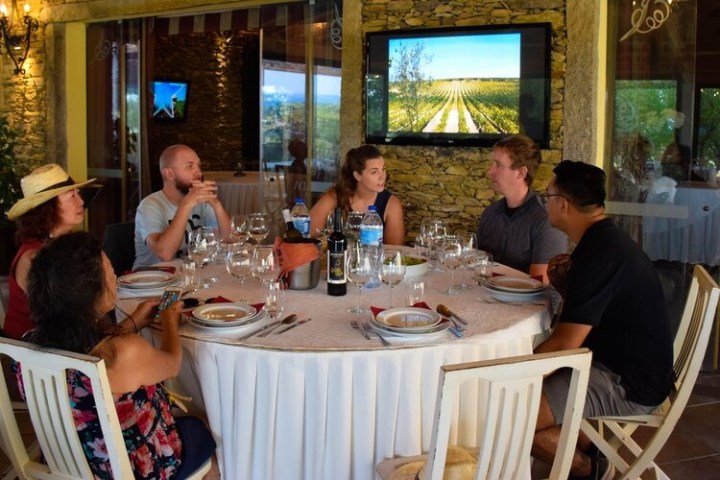 a group of people sitting at a table in a restaurant