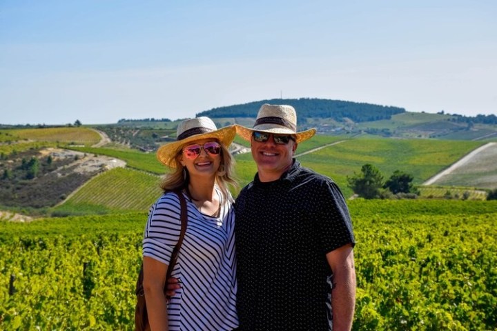 a man standing on top of a grass covered field