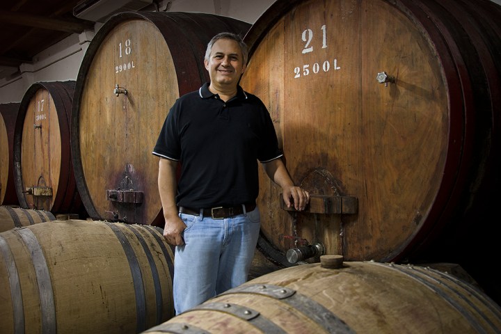a man standing in front of a barrel