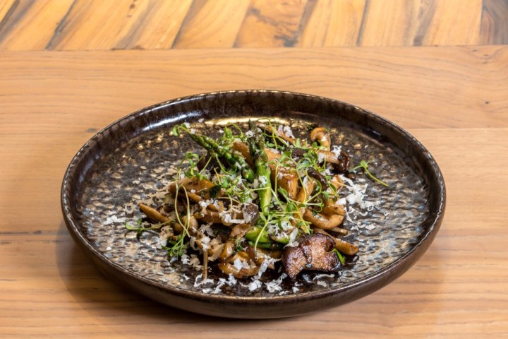a bowl of food sitting on top of a wooden table