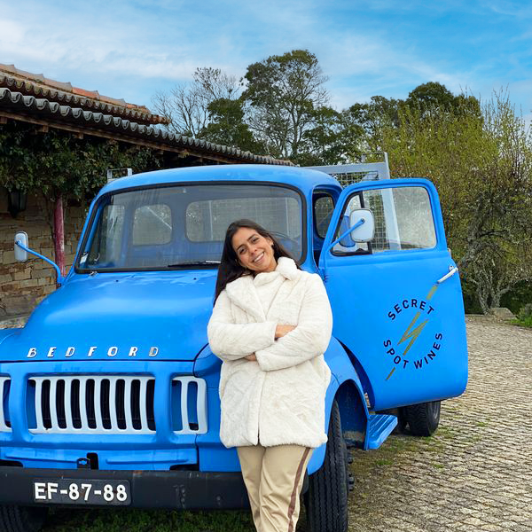 a person standing in front of a blue car